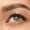 Beautiful young woman's eye close-up shot. Female model with well-kept skin. Perfect skincare, human emotions, facial expression, beauty and cosmetics concept. Deep blue-gray color and eyebrows.