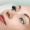 Eyelash extension procedure. Woman eye with long eyelashes. Close up